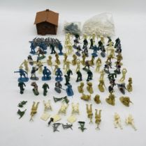 A collection of mainly unpainted plastic toy figurines including soldiers, scouts etc, along with