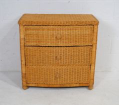 A bow-fronted wicker chest of three drawers - length 82cm, depth 46cm, height 79cm