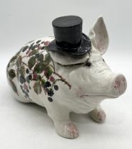 A large Wemyss pig with top hat decorated in bramble and blackberry pattern, signed to the underside