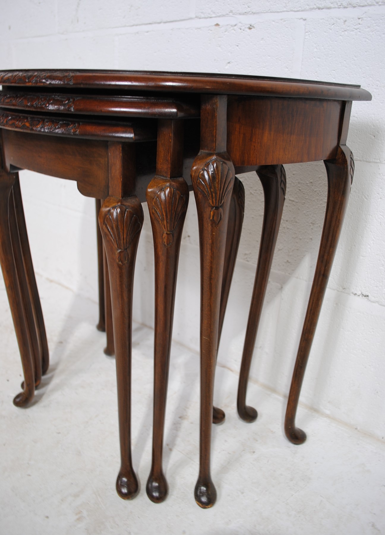 A walnut veneered nest of three demi-lune tables, with carved decoration, raised in cabriole legs - Image 6 of 6