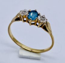 A 9ct gold three stone ring set with a topaz, size T 1/2