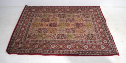 A Persian style red ground rug - 170cm x 230cm