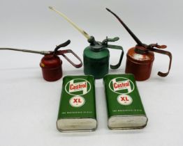 Three vintage oil cans including one by Wesco, along with two small Castrol oil cans