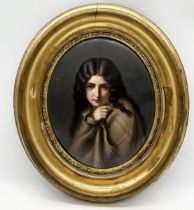 A late nineteenth century porcelain oval plaque painted with a portrait of a young girl wrapped in a