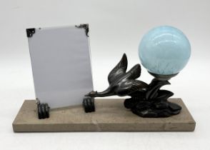 An Art Deco bronze patinated spelter bird design lamp with blue glass shade and picture frame signed