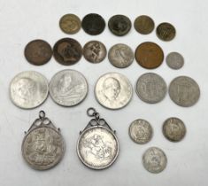 A small collection of coins including an 1819 and 1935 silver crown in pendant mounts