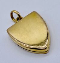 A shield shaped yellow metal locket- tests as 9ct gold, weight 7.7g