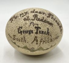 A decorated ostrich egg which reads "To my dear friends at Redcar from George Tench, September South