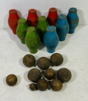 A set of nine painted wooden skittles, along with a selection of various sized skittle balls