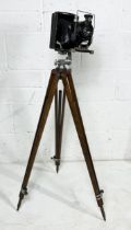 A Voigtlander Compur folding plate camera on wooden tripod stand