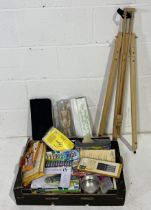 A collection of various arts supplies including easel, paints, pastels, brushes etc.