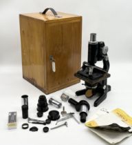A Watson "Service" Microscope in original wooden box with numerous lenses, fittings etc.
