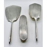 A hallmarked silver three piece dressing table set