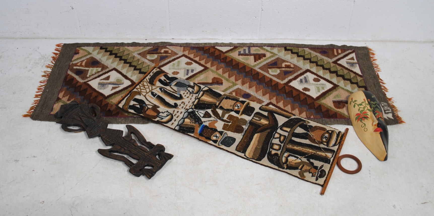 Two African tribal wall hangings, along with a carved tribal figure etc.