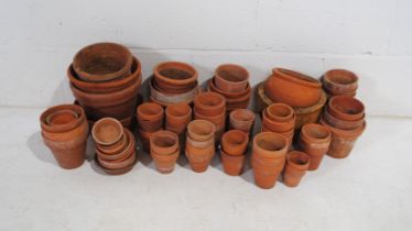 A quantity of various sized terracotta garden plant pots in two boxes