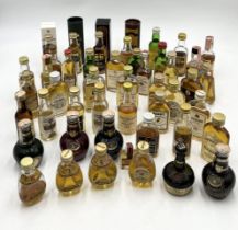 A collection of miniature whisky bottles including Dunhill, Haig, Dimple, Glen Grant, Macallan,