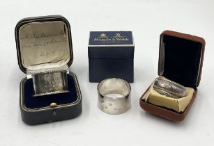 A boxed Mappin & Webb silver serviette ring along with two others