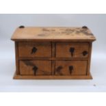 A Mexican pine table-top chest of four drawers - length 50cm, depth 30cm, height 26.5cm