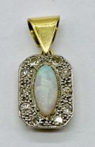 An unmarked Art Deco gold pendant set with diamonds and an opal