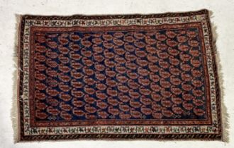 A red ground Eastern rug with interior repeating pattern and geometric border design