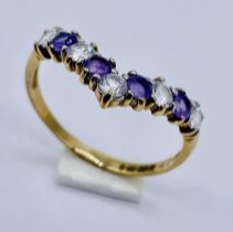 An amethyst wishbone shaped dress ring set in 9ct gold, size P