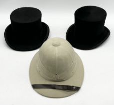 Two vintage top hats along with a pith helmet