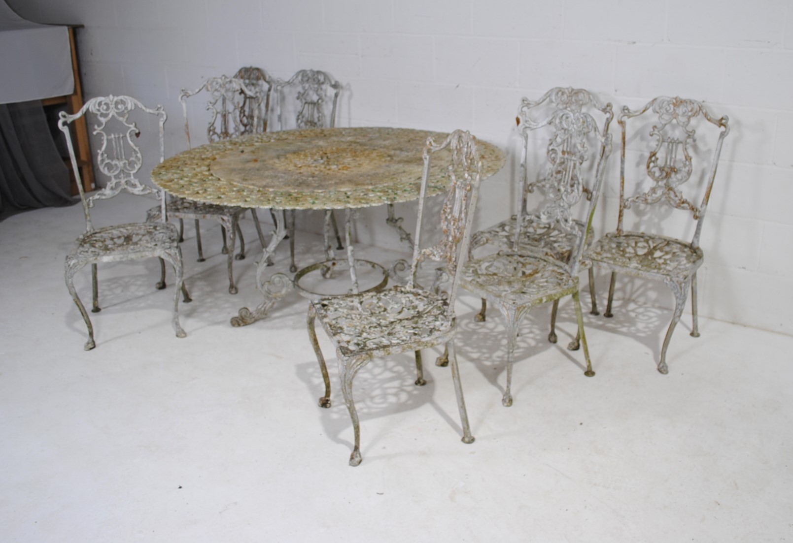 A weathered cast aluminium circular garden table with a set of eight chairs, with lyre backs - one - Image 2 of 12
