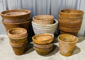 A collection of various sized terracotta pots