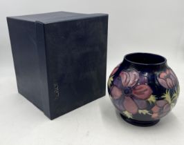 A boxed Moorcroft vase in the Anemone pattern, signed and numbered to base - height 18cm