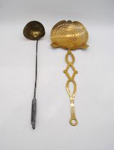 An antique brass strainer ladle along with a brass skimmer