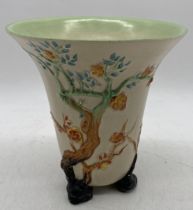A Clarice Cliff trumpet shaped vase decorated with branches and foliage, height 20cm