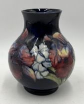 A Moorcroft vase in the Orchid pattern, signed and impressed to base - height 20cm