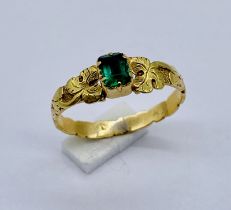 An antique 18ct gold (tested) child's ring set with an emerald, size F