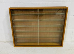 A wooden framed display cabinet with sliding glass doors - overall size height 65cm, width 81cm,