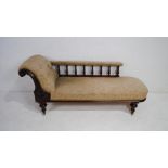 A Victorian upholstered chaise longue, with carved decoration, raised on turned legs - length 192cm