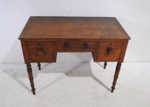 A Victorian mahogany side table, with three drawers, raised on turned legs - length 99cm, depth 51.