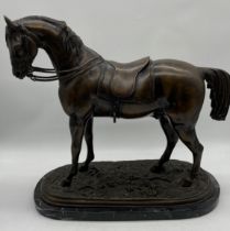 A large Victorian bronze sculpture of a saddled horse on naturalistic base. Indistinct signature "