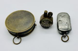 A trench art lighter made from Prince Alberts Own regimental buttons, a French compass and a steel