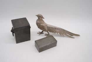 Two pewter boxes along with a metal figure of a pheasant