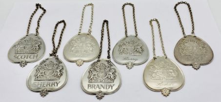 A set of seven bottle labels commemorating the Queens silver jubilee by Robert Belks, total weight