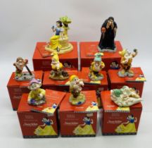 A collection of boxed Disney Showcase Collection Snow White and the Seven Dwarfs figurines, along