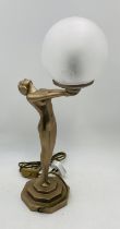 An Art Deco style table lamp in the form of a nude lady holding a globe - Overall height 50cm