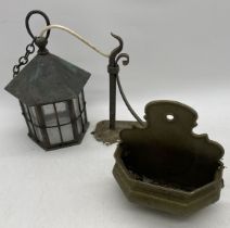 A vintage copper lantern along with a brass wall pocket