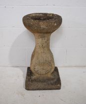 A weathered reconstituted stone garden bird bath - length 32.5cm, depth 31cm, height 66cm