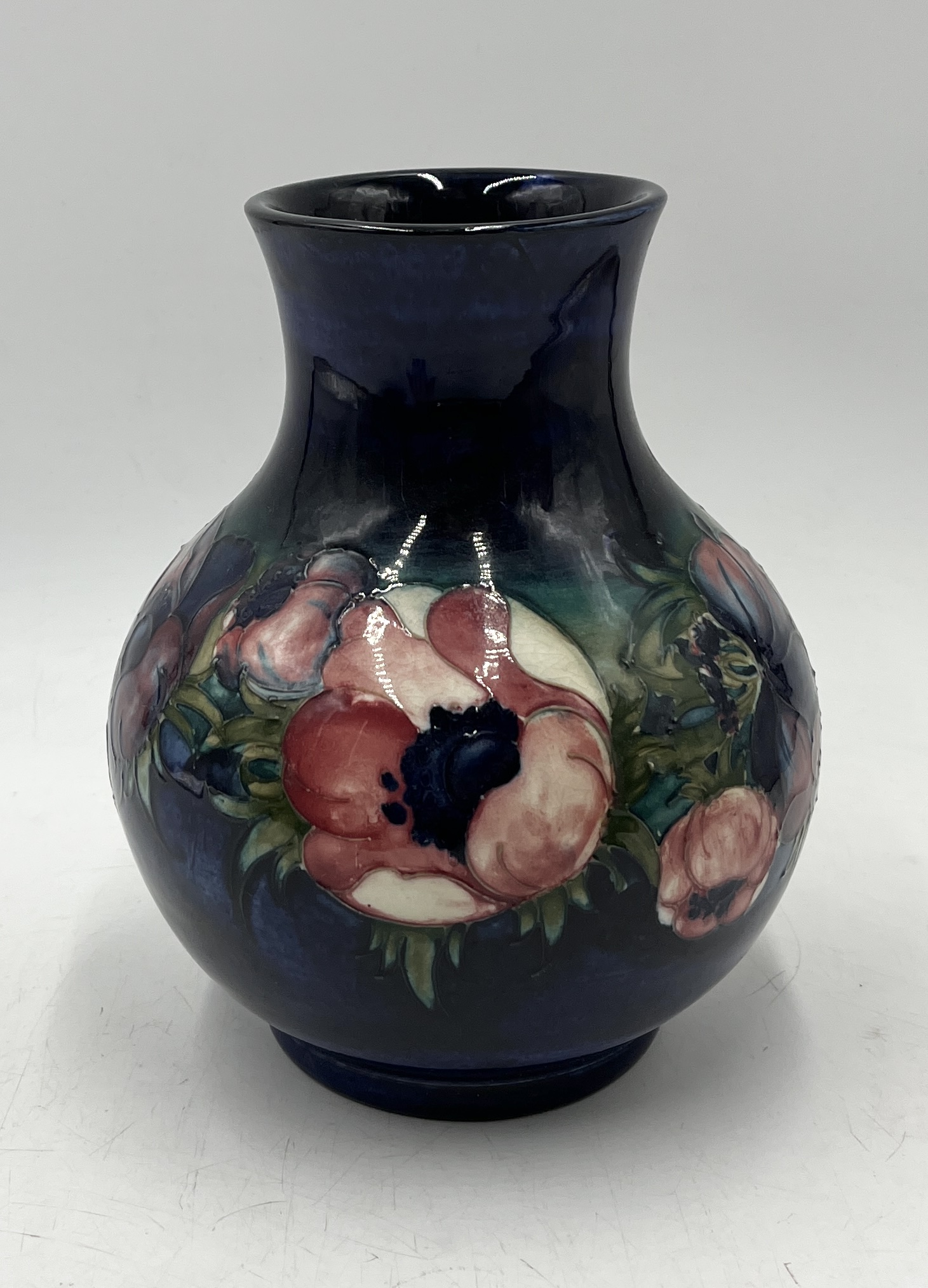 A Moorcroft vase in the Anemone pattern, signed to base and impressed "Potter to H.M. The Queen" -