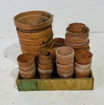 A collection of various sized terracotta pots