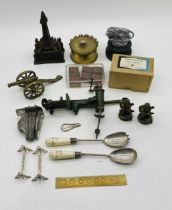 A collection of miscellaneous items including a cast iron money box in the form of Blackpool