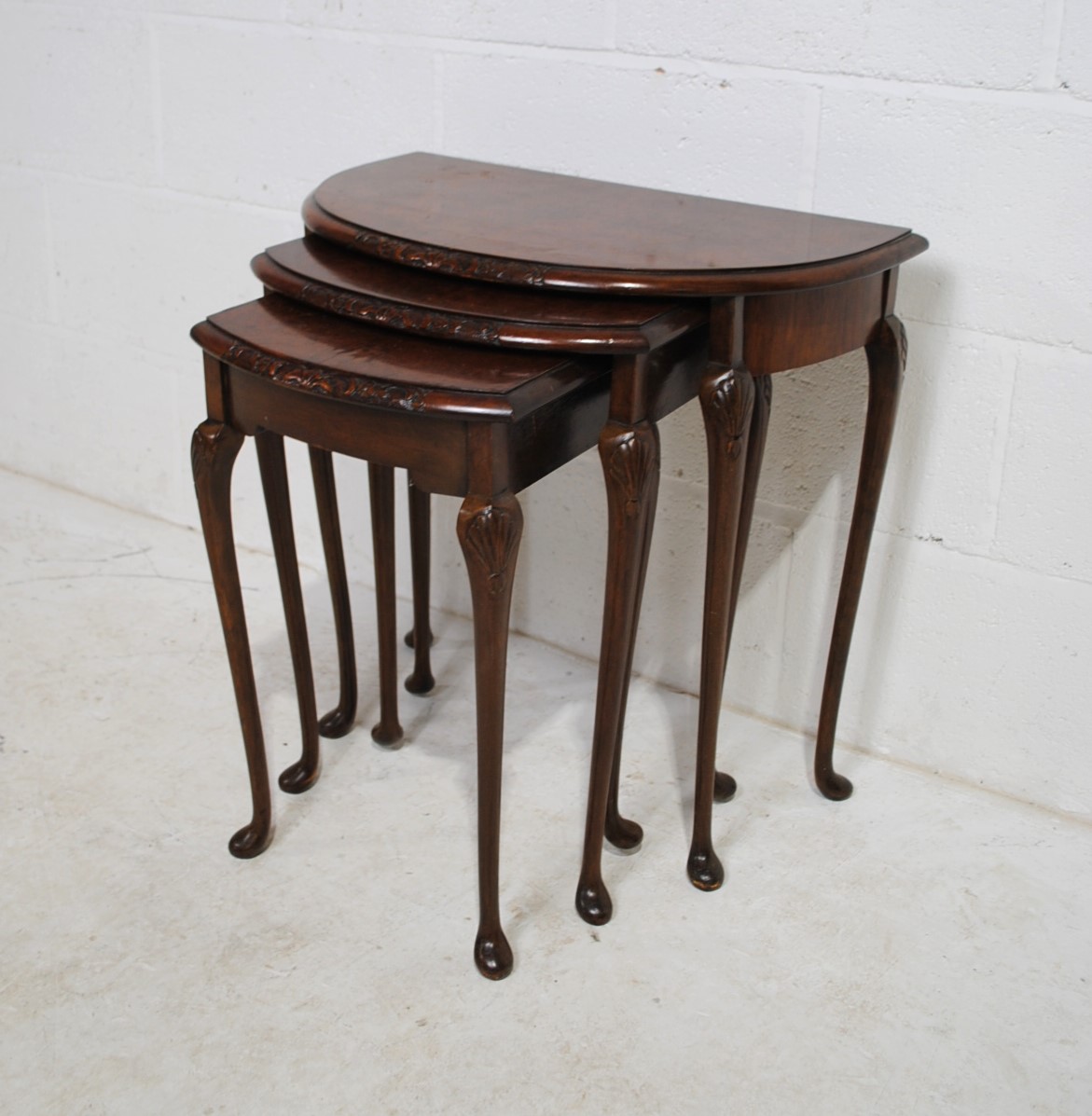 A walnut veneered nest of three demi-lune tables, with carved decoration, raised in cabriole legs - Image 3 of 6