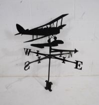 A wrought iron weathervane with a biplane