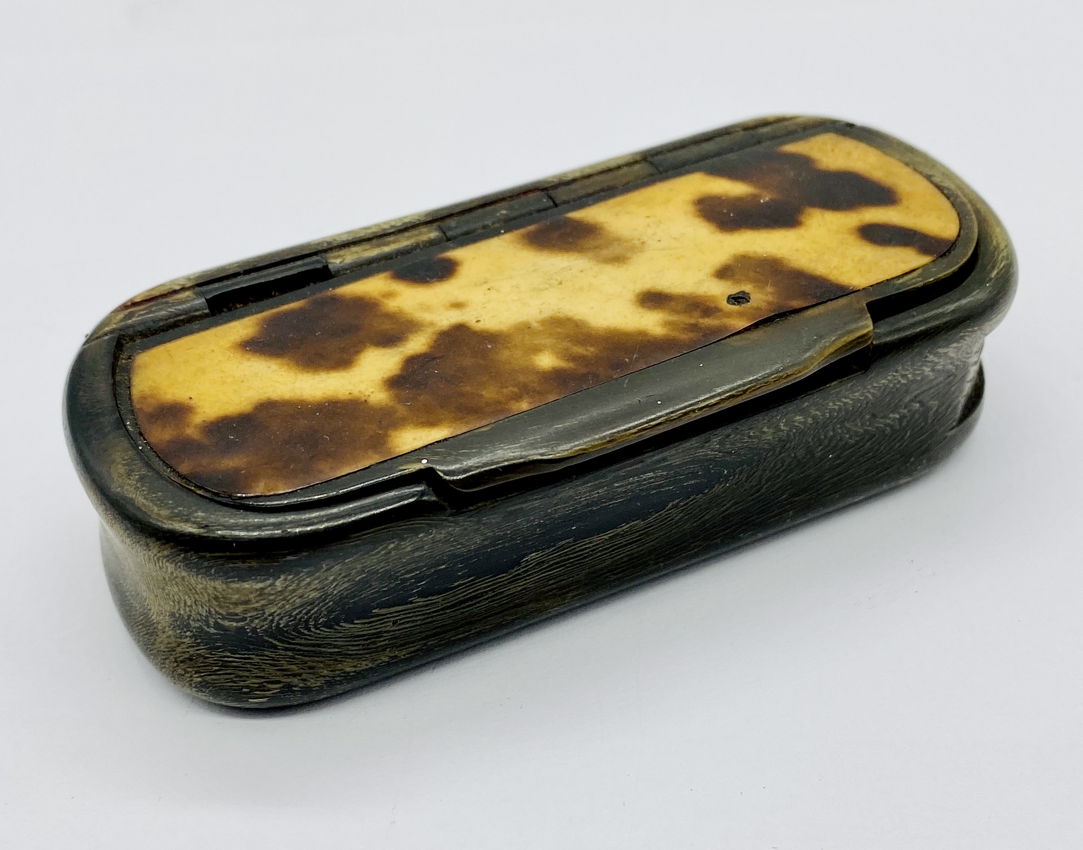 An antique tortoiseshell and horn snuff box